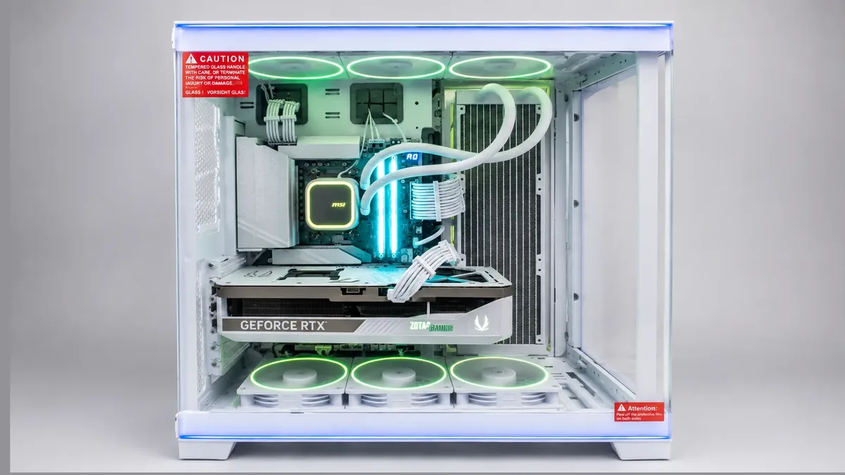 A custom gaming PC from our bench — white dual-chamber case, liquid cooler, and green RGB fans